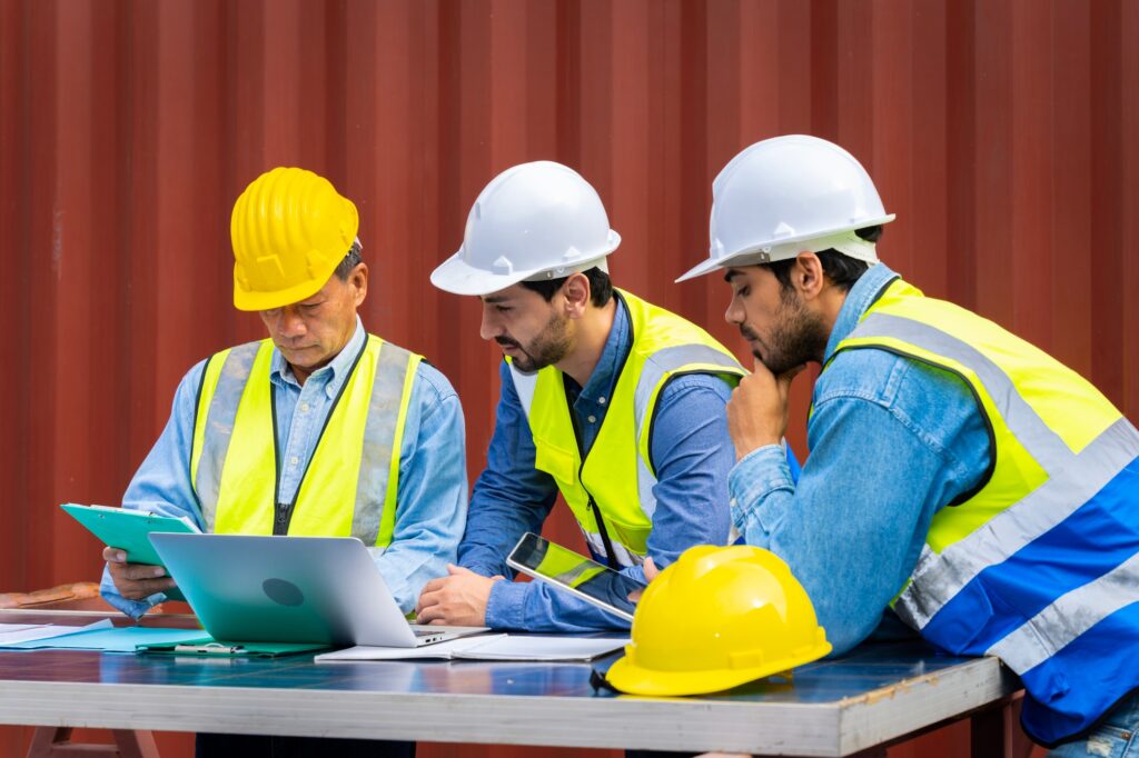 Group male engineers in a container shipping company
