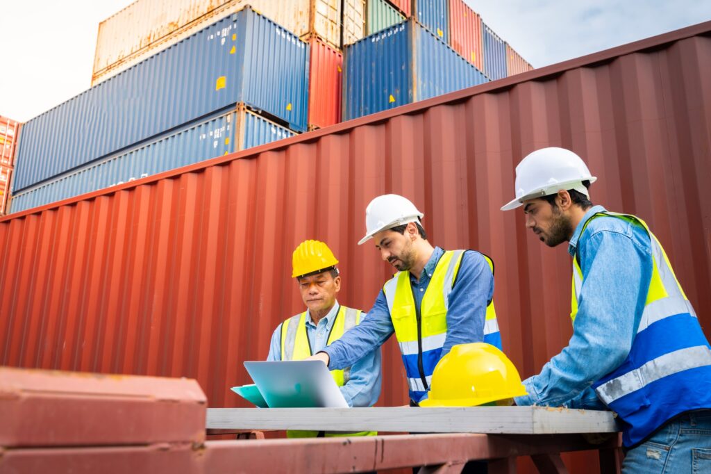 Group male engineers in a container shipping company