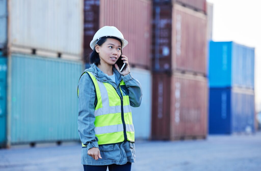 Logistics, phone call and woman talking about shipping container on a phone while working at port.