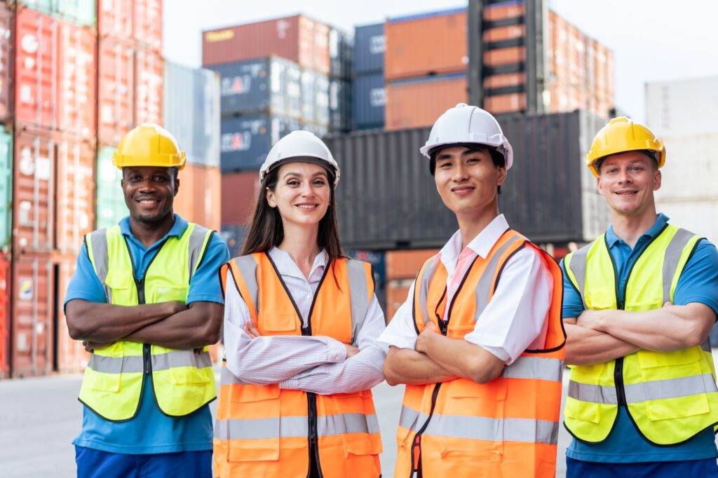 Portrait group of male and female worker working in container terminal.