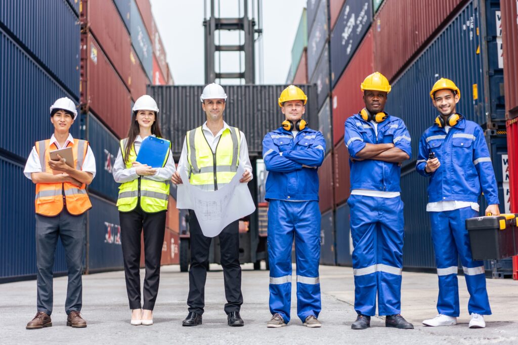 Portrait group of male and female worker working in container terminal.