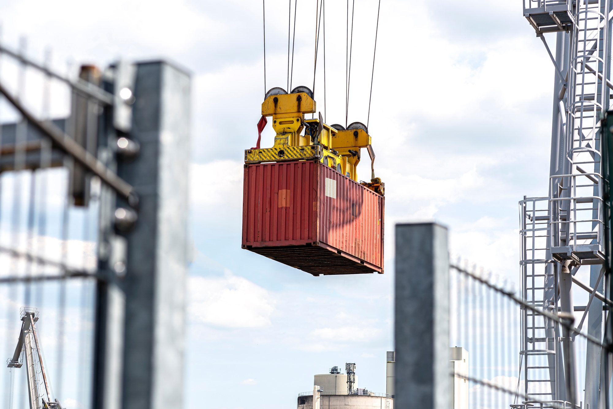 A container gantry crane on a rail loads the container into a barge